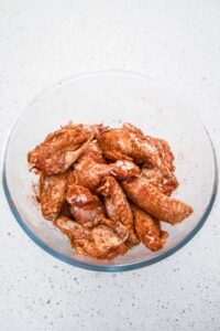 Spiced chicken wings in a bowl ready to cook
