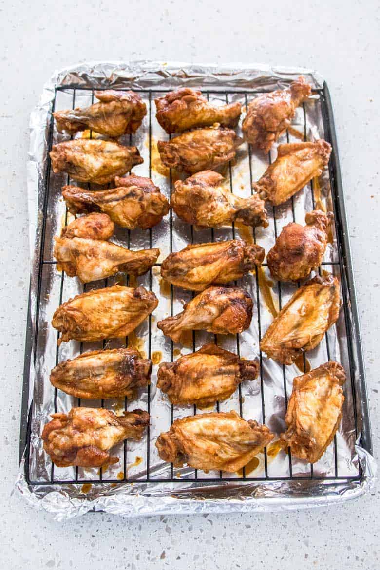 Chicken wings on a baking sheet with a rack