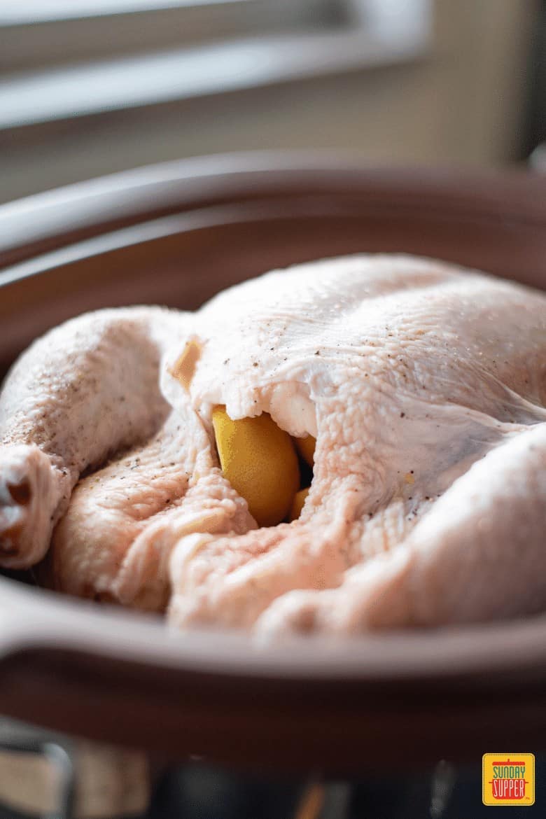 Slow Cooker Whole Chicken Filled with Lemon and ready to slow cook