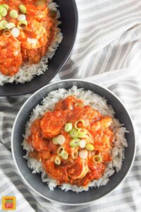 two bowls of shrimp creole served over rice