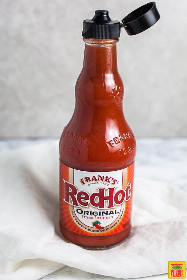 Frank's RedHot Sauce used in recipe on a counter