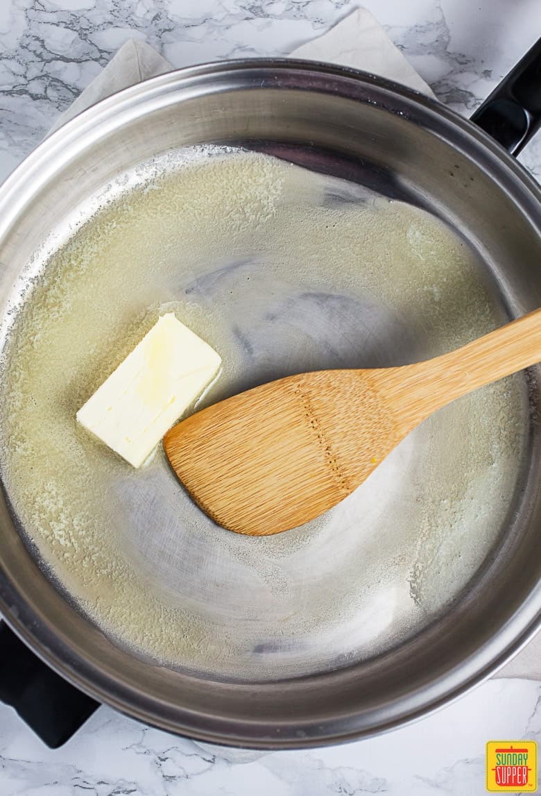 stirring butter in a pan for homemade buffalo sauce