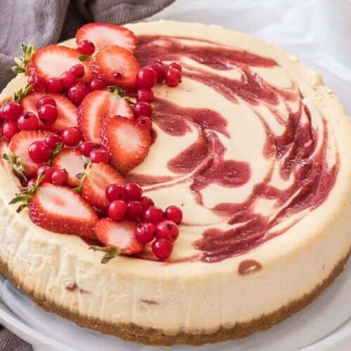 This beautiful Strawberry Swirl Cheesecake is easy to make at home and it's an absolute classic. Homemade strawberry sauce and smooth, creamy baked cheesecake. 