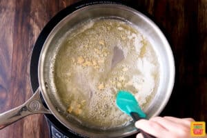 Sauteing garlic in a skillet with butter