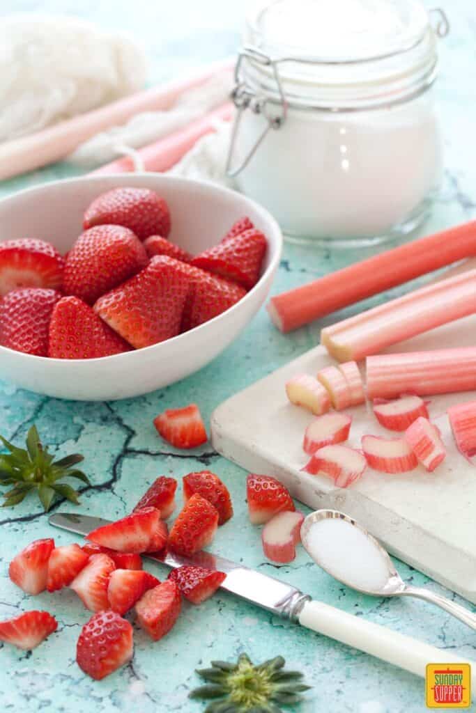 Cutting the strawberries and rhubarb for strawberry rhubarb jam