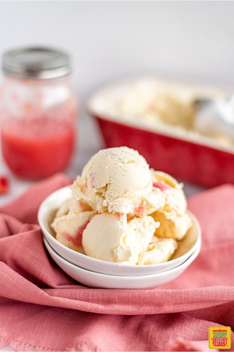 Scoops of rhubarb ice cream served in a white dish