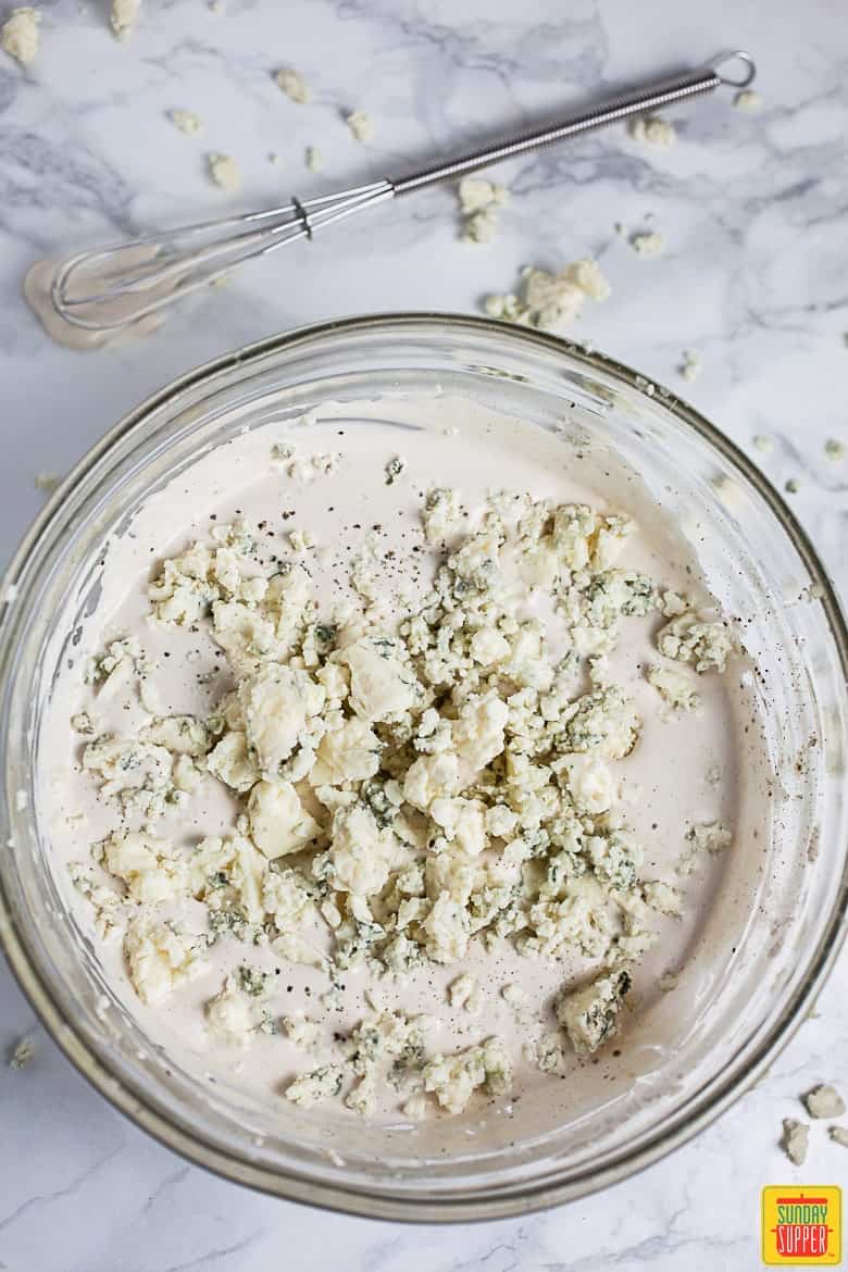 Mixing blue cheese crumbles into the dressing with a tiny whisk on the side