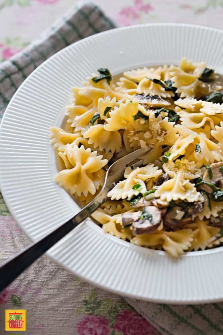 Mushroom Spinach Pasta on a plate with a fork