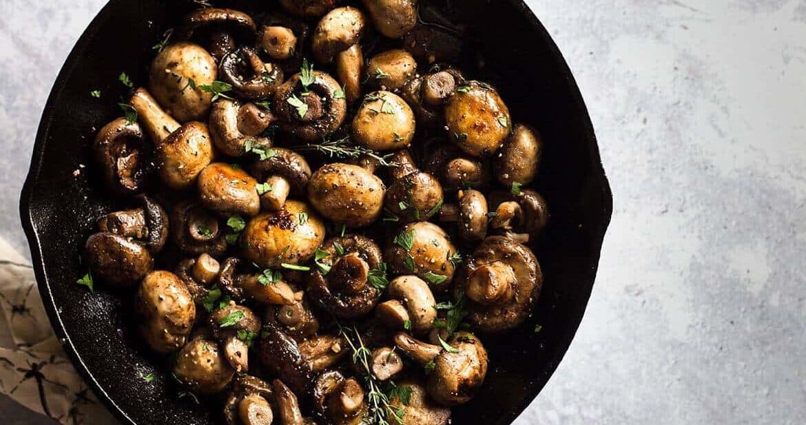 Button Mushrooms Recipe served in a cast iron skillet