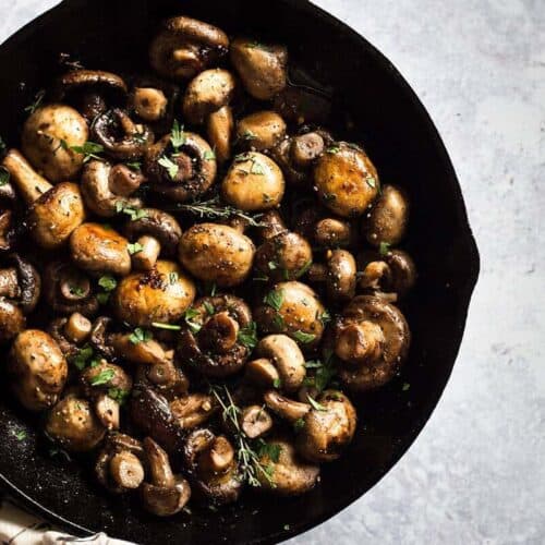 Button Mushrooms Recipe served in a cast iron skillet