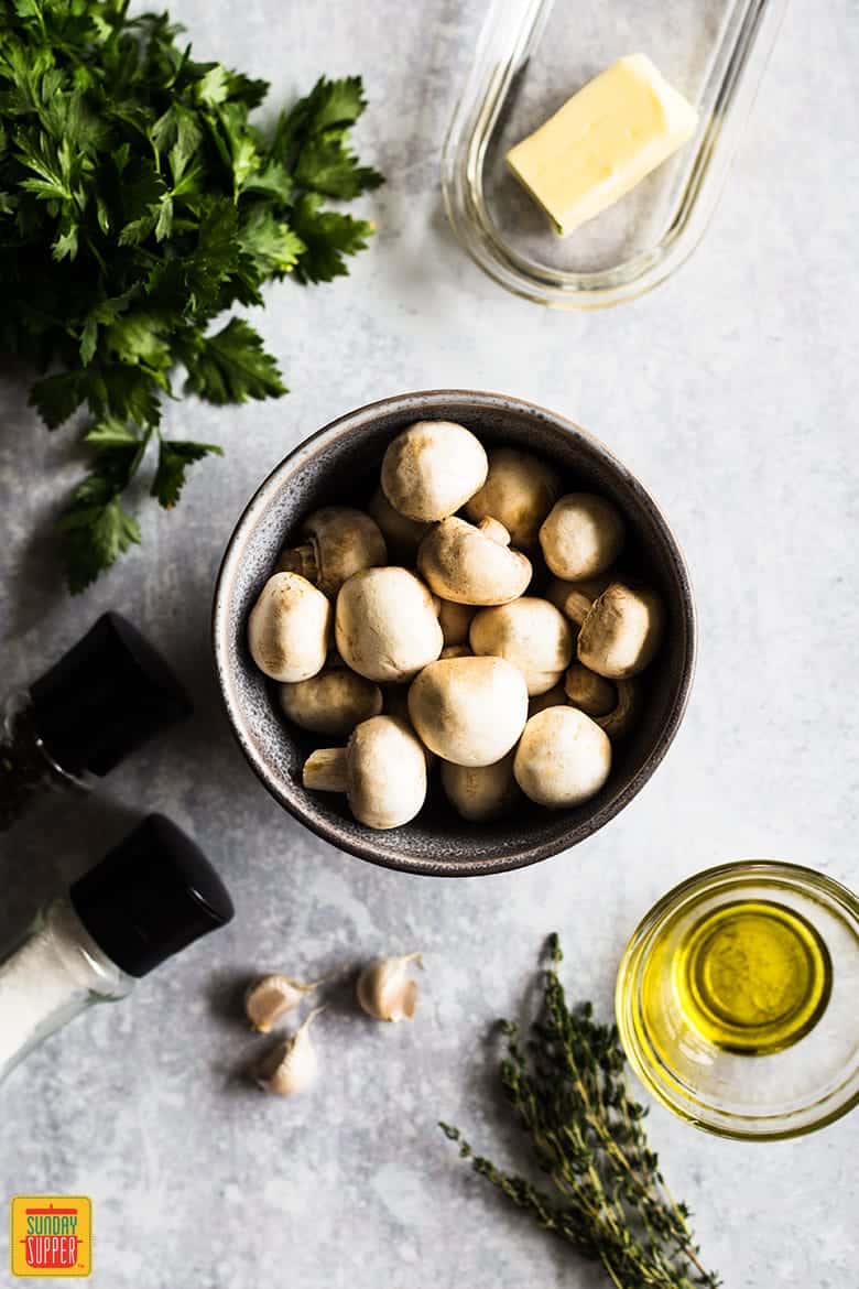 Ingredients for button mushrooms recipe laid out on counter