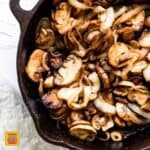 sautéed mushrooms and onions in a black cast iron skillet