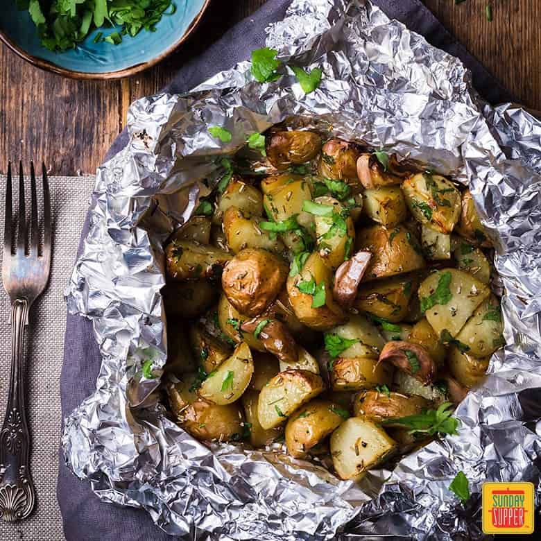 Foil pack potatoes served in the foil with fresh parsley