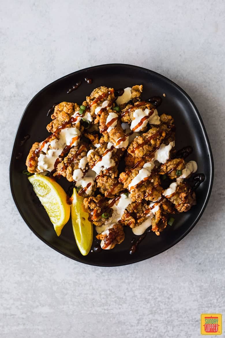 Fried oysters topped with barbecue sauce and blue cheese dressing