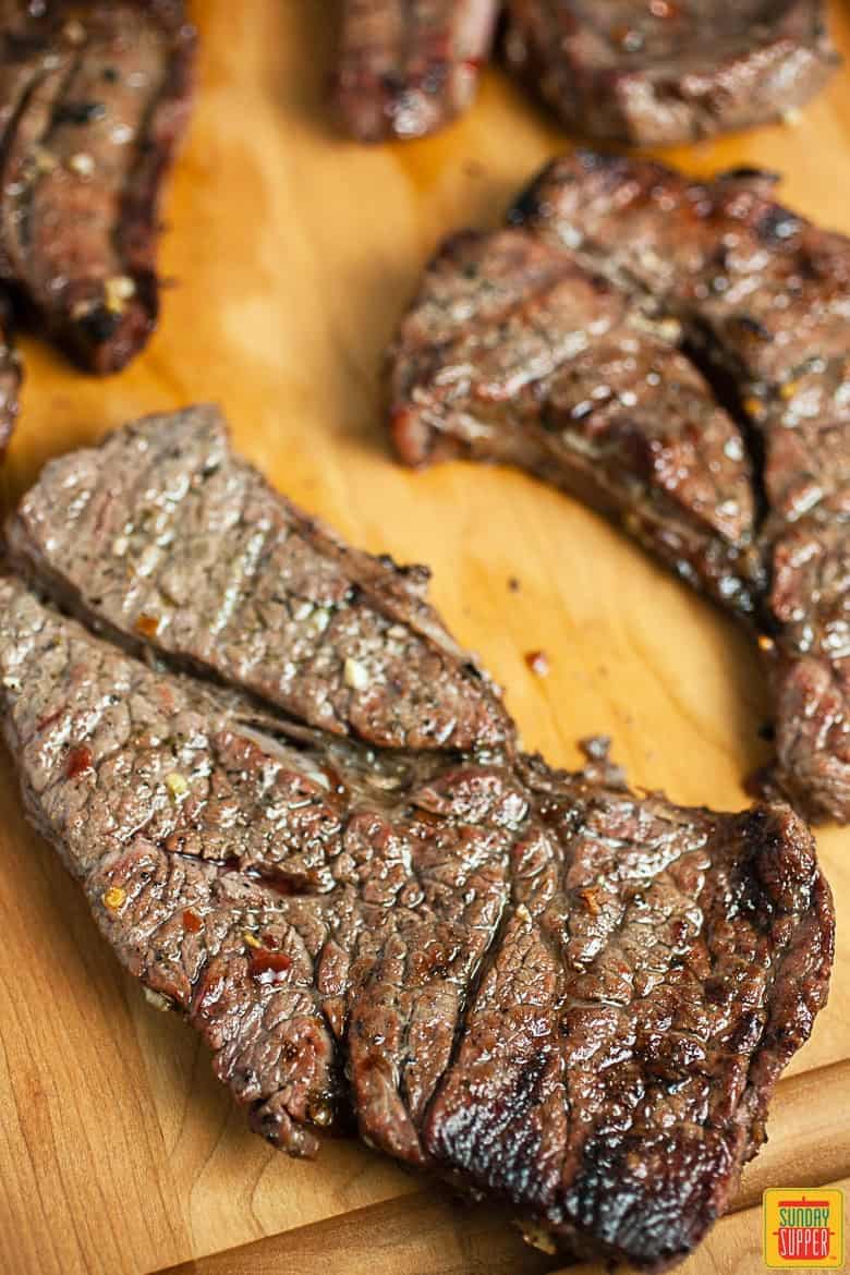 Grilled chuck steaks on a cutting board