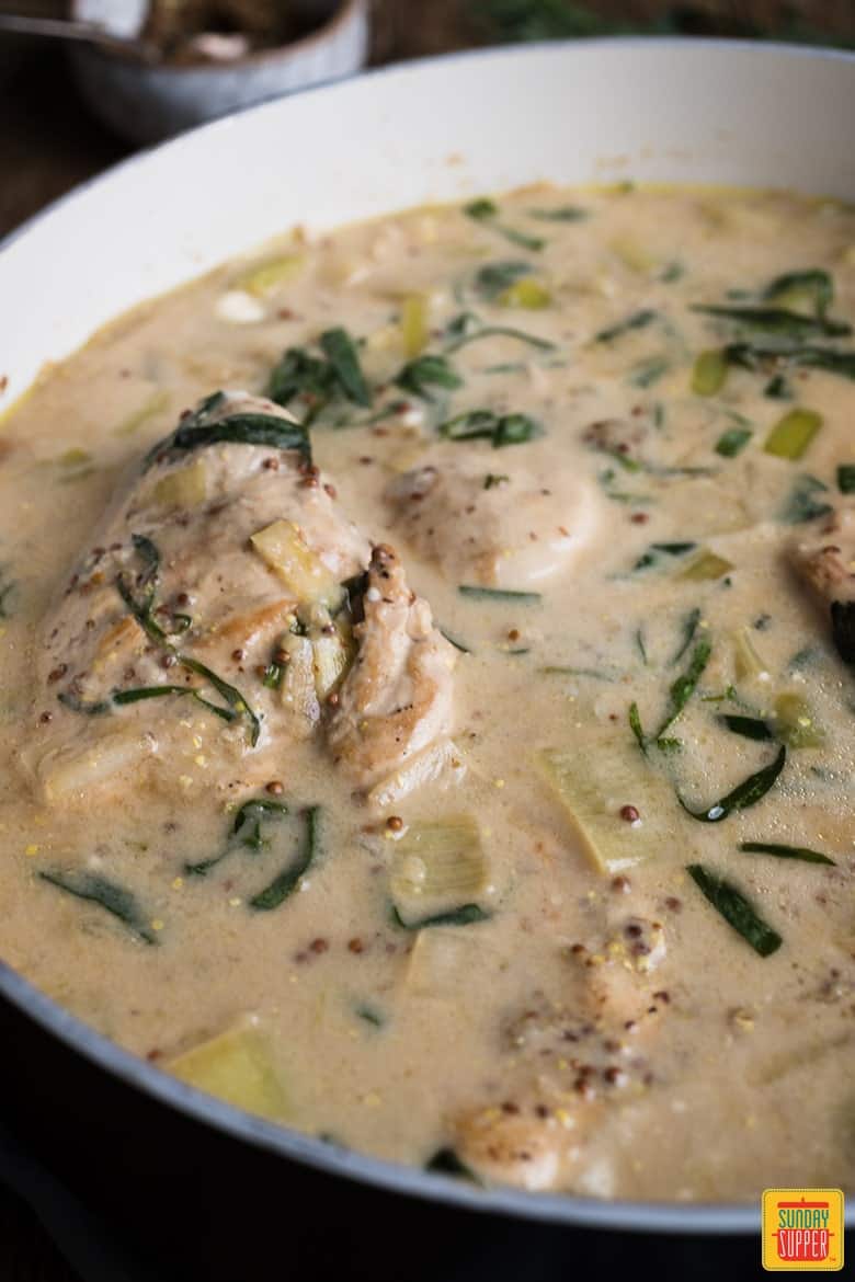 chicken and leek recipe with tarragon up close in the pan