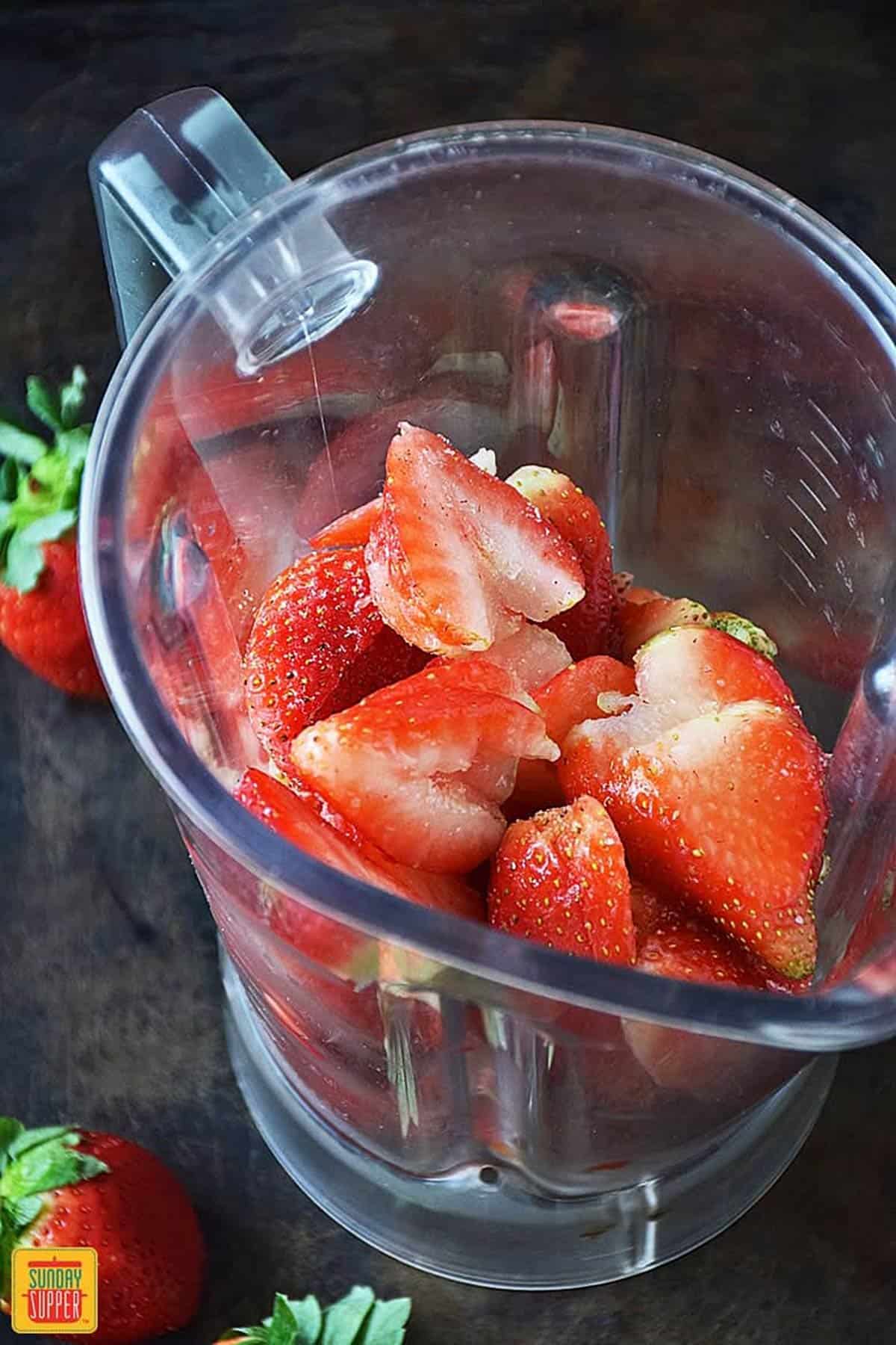 Frozen sliced strawberries in a blender