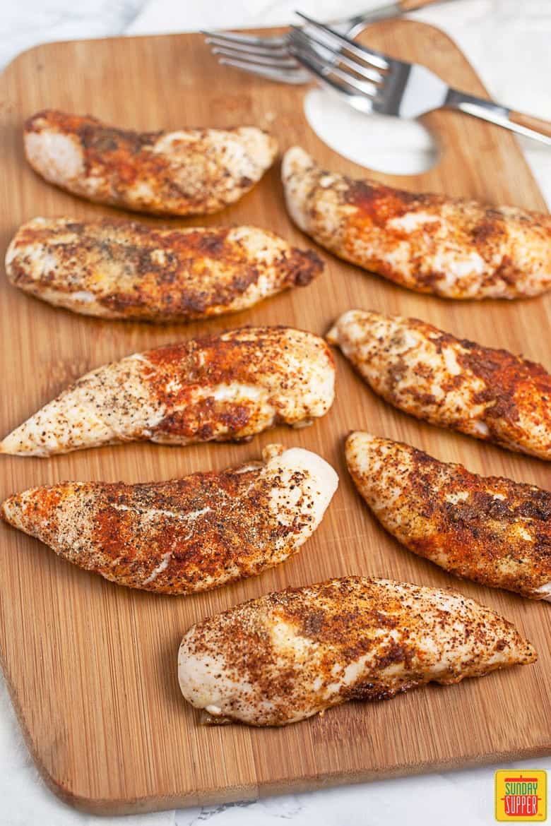 Spiced and Baked Chicken Breast Tenders On Cutting Board