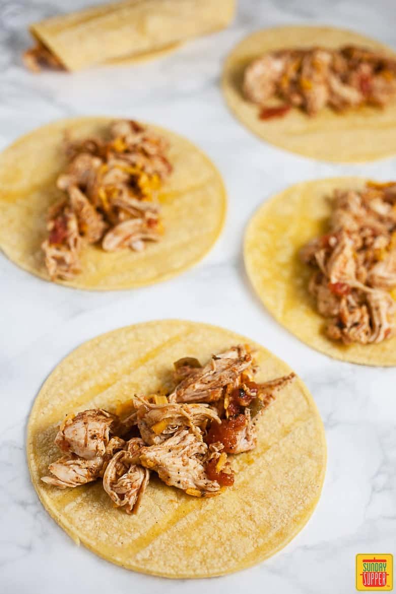 Shredded Chicken Added To Corn Tortillas and Rolled Tightly