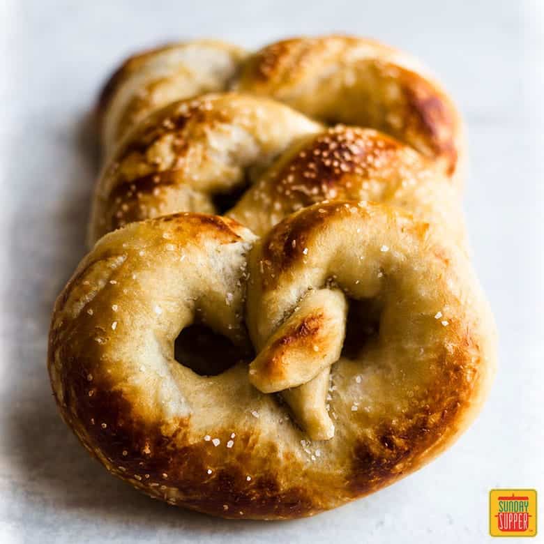 Soft Pretzel Recipe: a row of soft pretzels on a white background