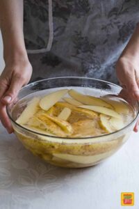 Soaking potato wedges in a big bowl of water