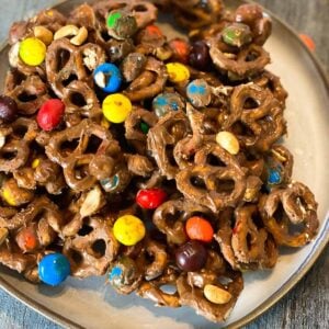 Close up of chocolate peanut butter pretzels snack mix on a plate
