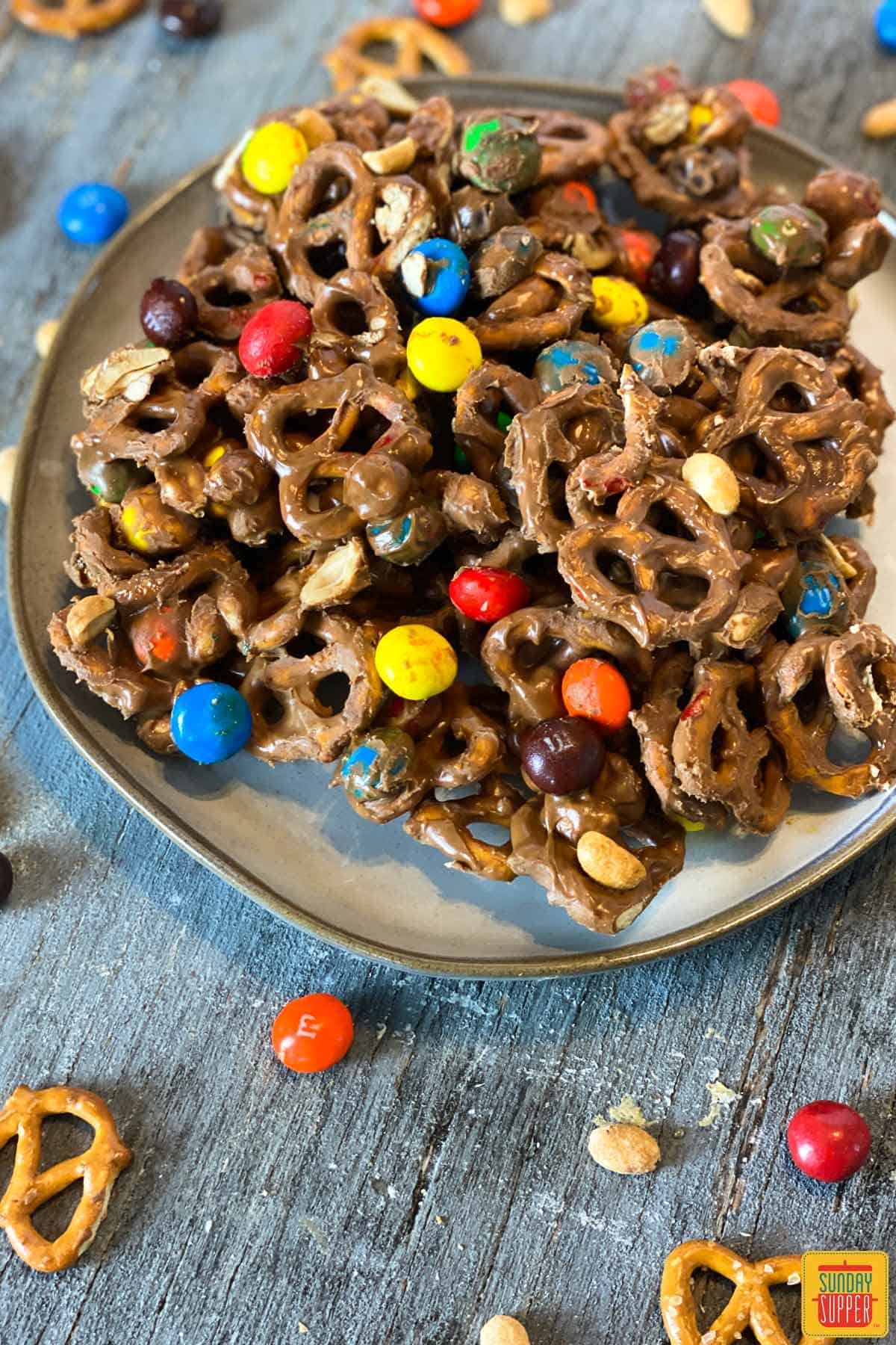 A plate with chocolate peanut butter M&Ms snack mix