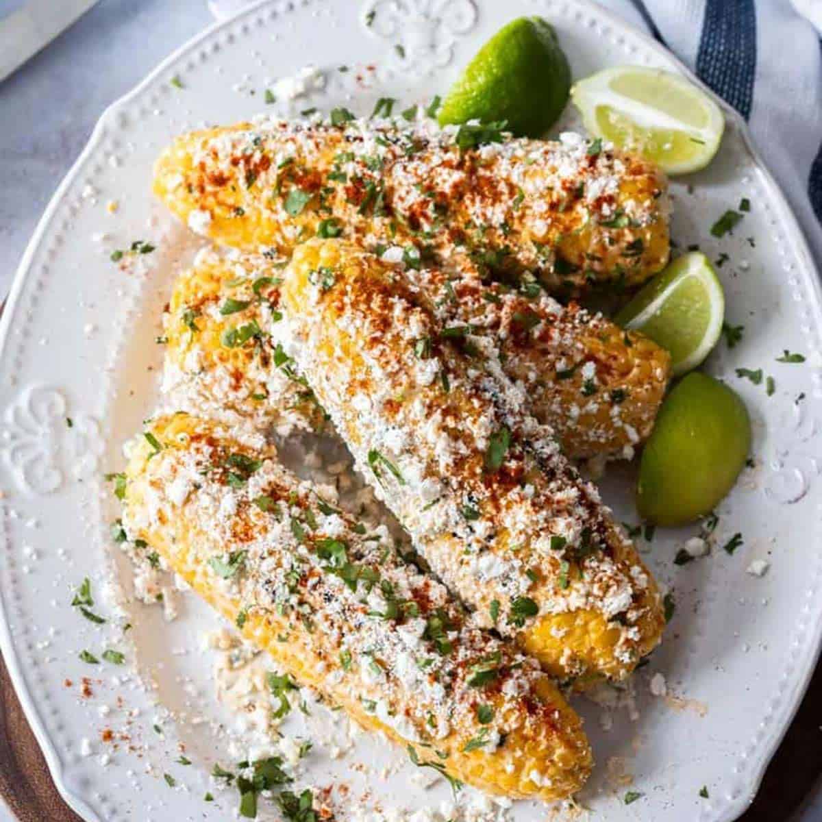Elotes Mexicanos on a white platter