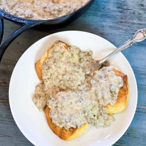 A plate of stovetop sausage gravy over biscuits