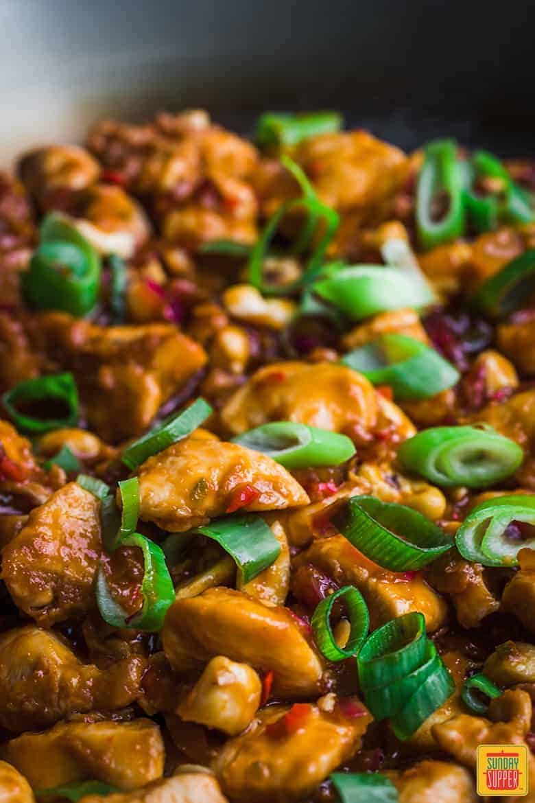 Close up of Dragon Chicken in a wok with spring onions