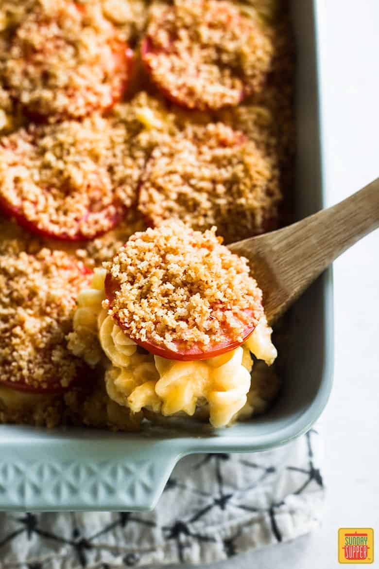 Ina Garten Mac and Cheese in casserole dish with sliced tomatoes