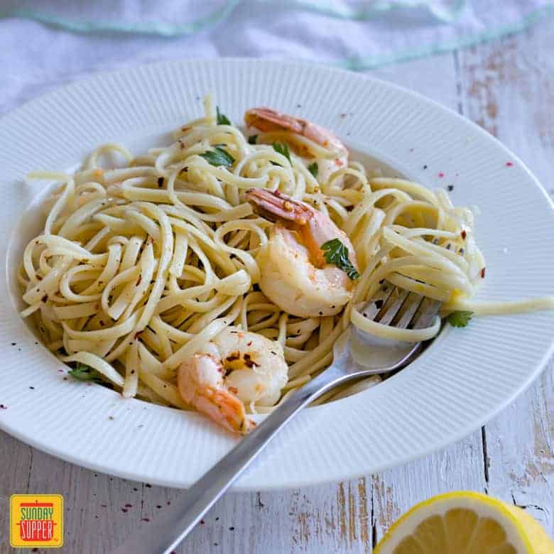 Shrimp Scampi Linguine served in a white plate 