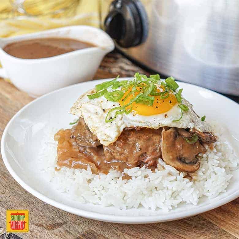 Slow Cooker Beef Gravy with Loco Moco and white rice on a white plate