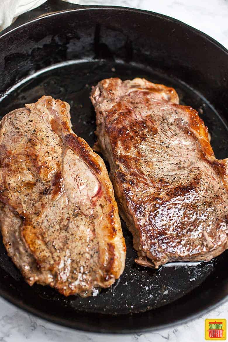 Seared New York Strip Steaks In Cast Iron Skillet 