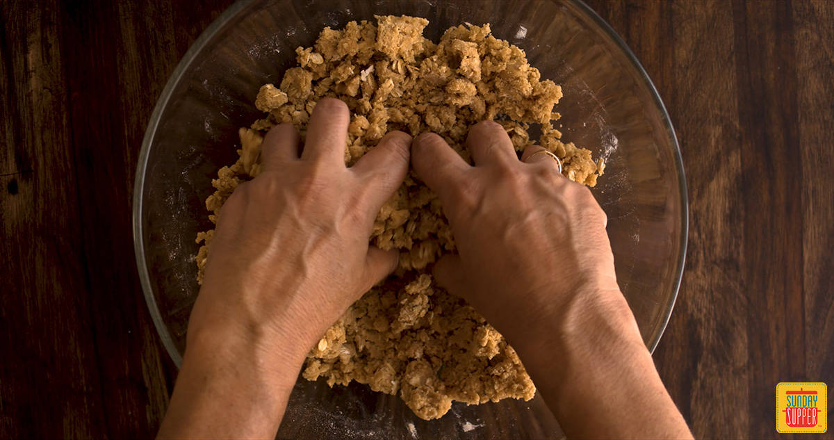 Crumbing the apple streusel topping with hands