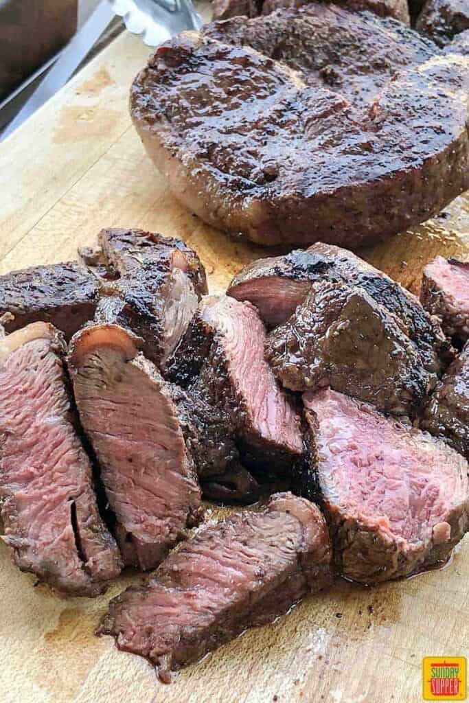 Cuts of cooked beef on a cutting board