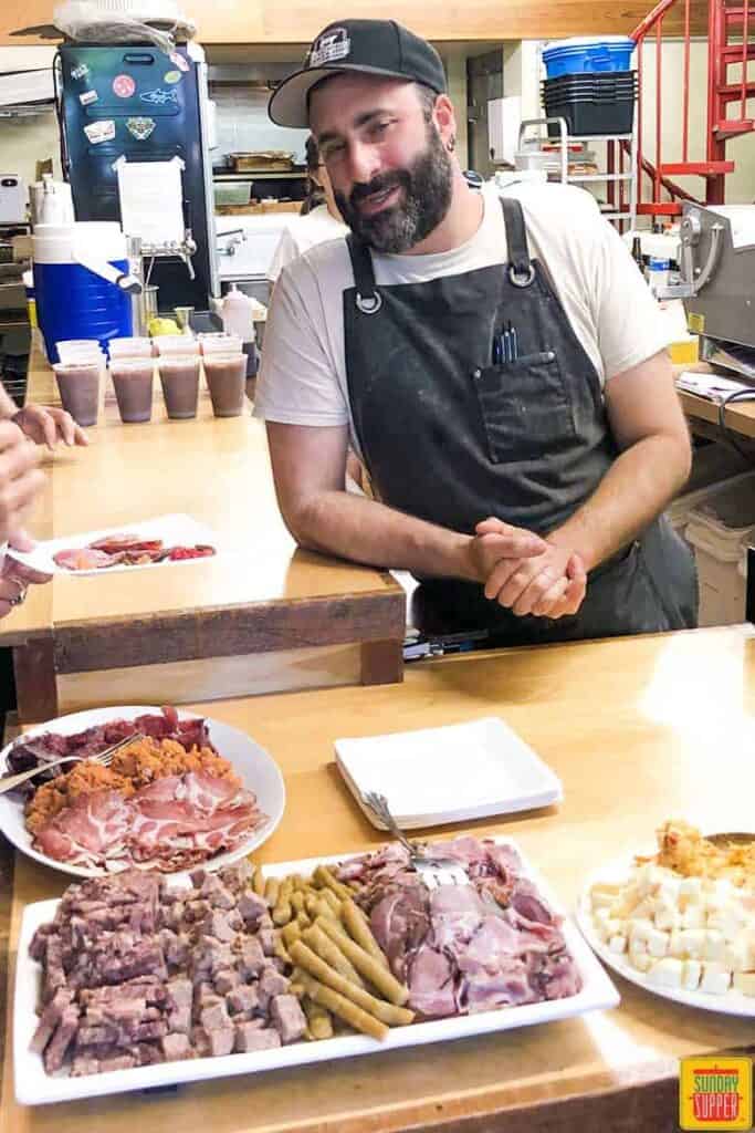 chef Jeremy Umansky at Larder with a charcuterie plate in front of him