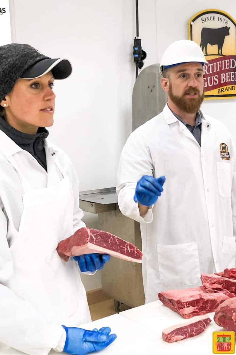 Certified Meat Scientist Diana Clark and Chef Gavin with cuts of beef in their Meat Lab coats, gloves and hats