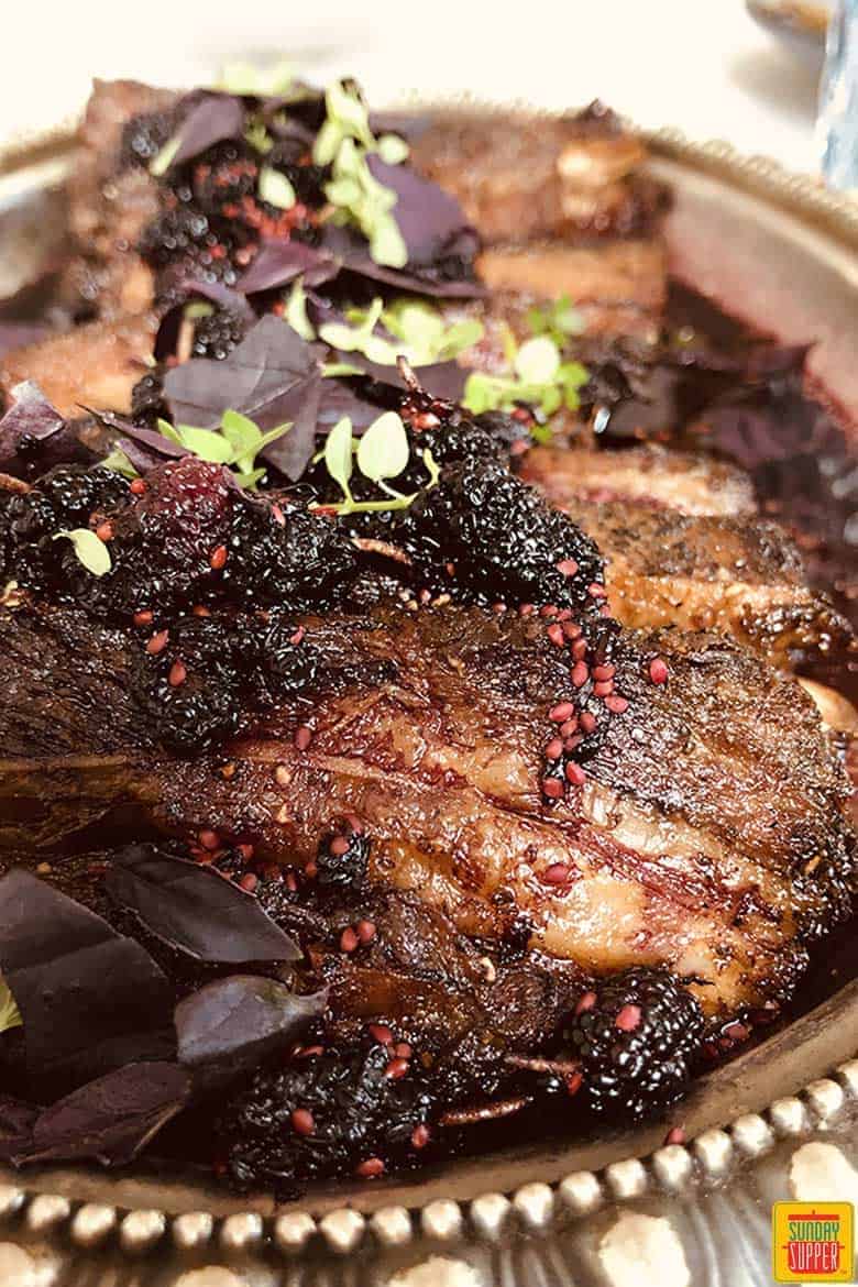 Beef Belly with Macerated Berries on a platter