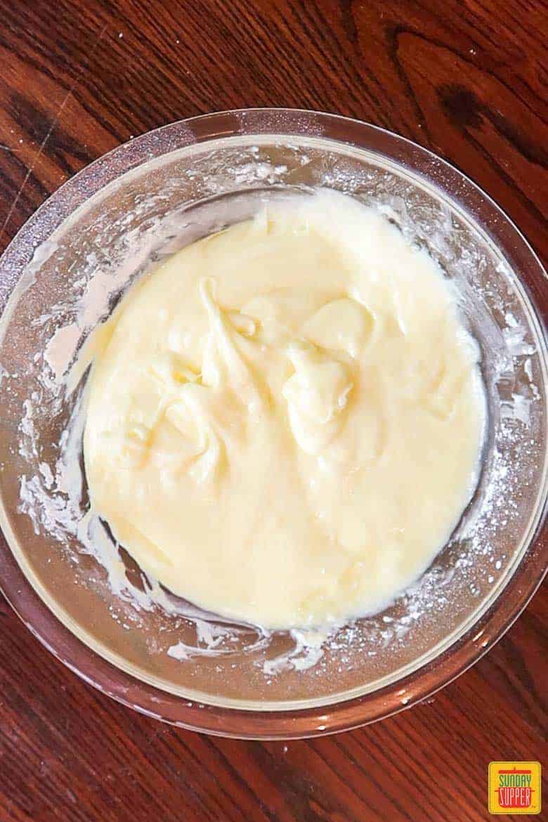 ooey gooey butter cake batter in a mixing bowl