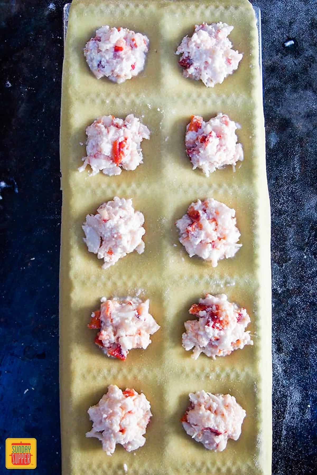 Ravioli lobster filling on sheets of pasta dough