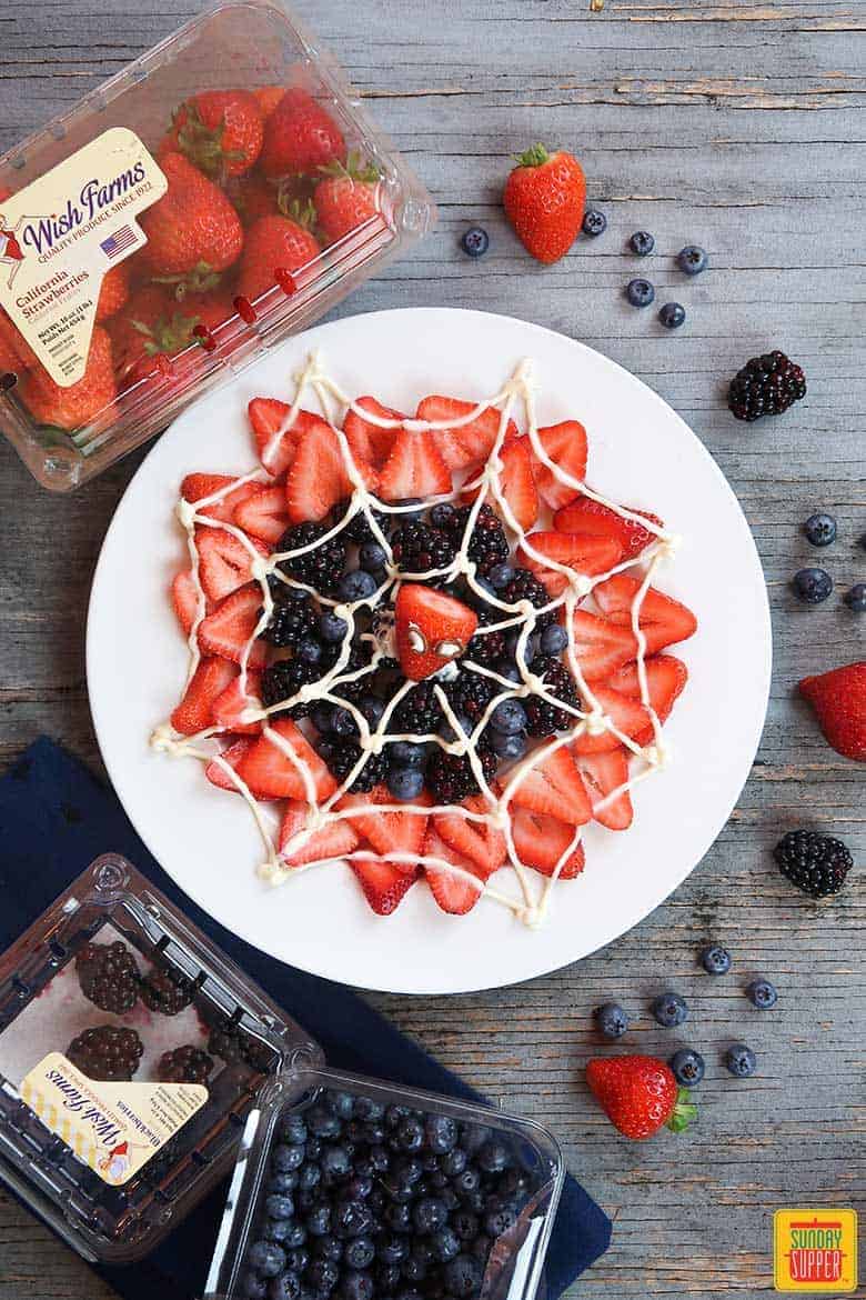 spider-man web berry dessert on white plate ready to enjoy