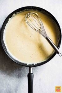 Cream sauce in skillet for Easy Scalloped Potatoes Recipe