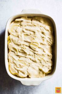 Layered potatoes and cream sauce for Easy Scalloped Potatoes Recipe
