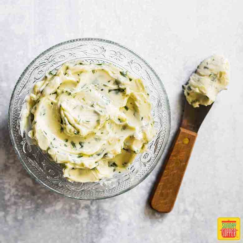 Garlic Butter Recipe in small glass bowl with knife
