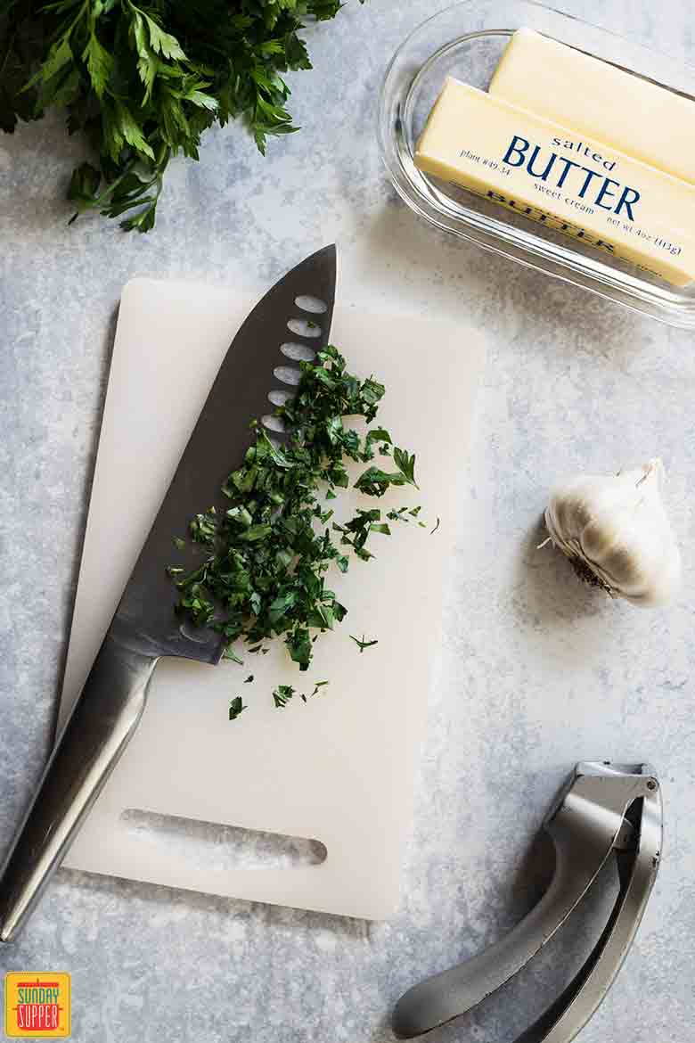 Chopping herbs for Garlic Butter Recipe