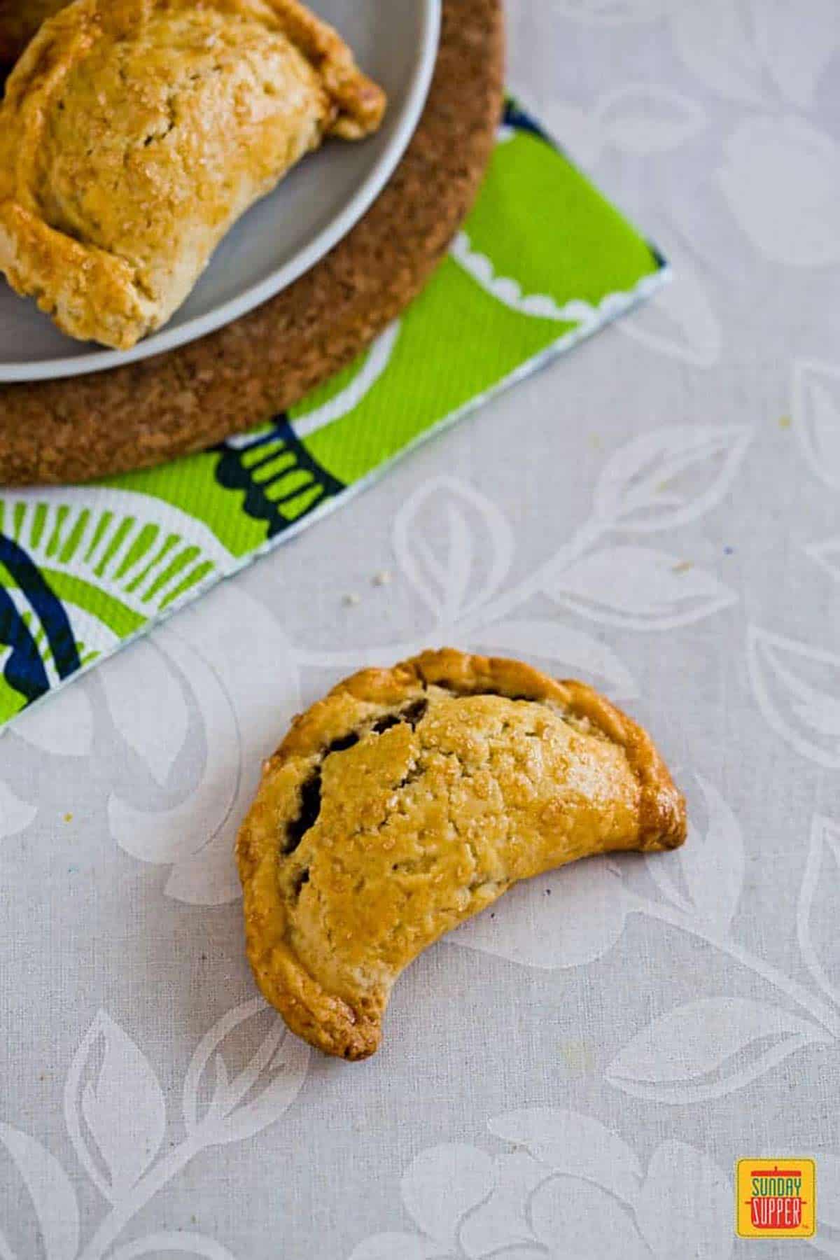 Baked pumpkin empanadas served in a plate on the table