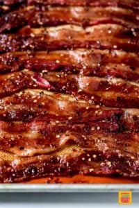 cooked candied bacon on a lined sheet pan
