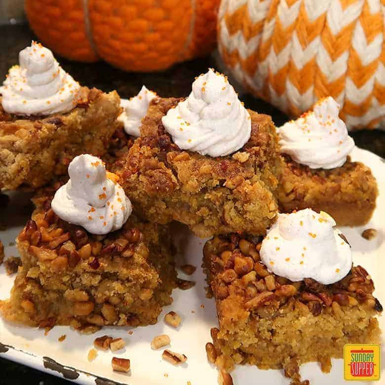 Pumpkin crunch cake squares on a white platter