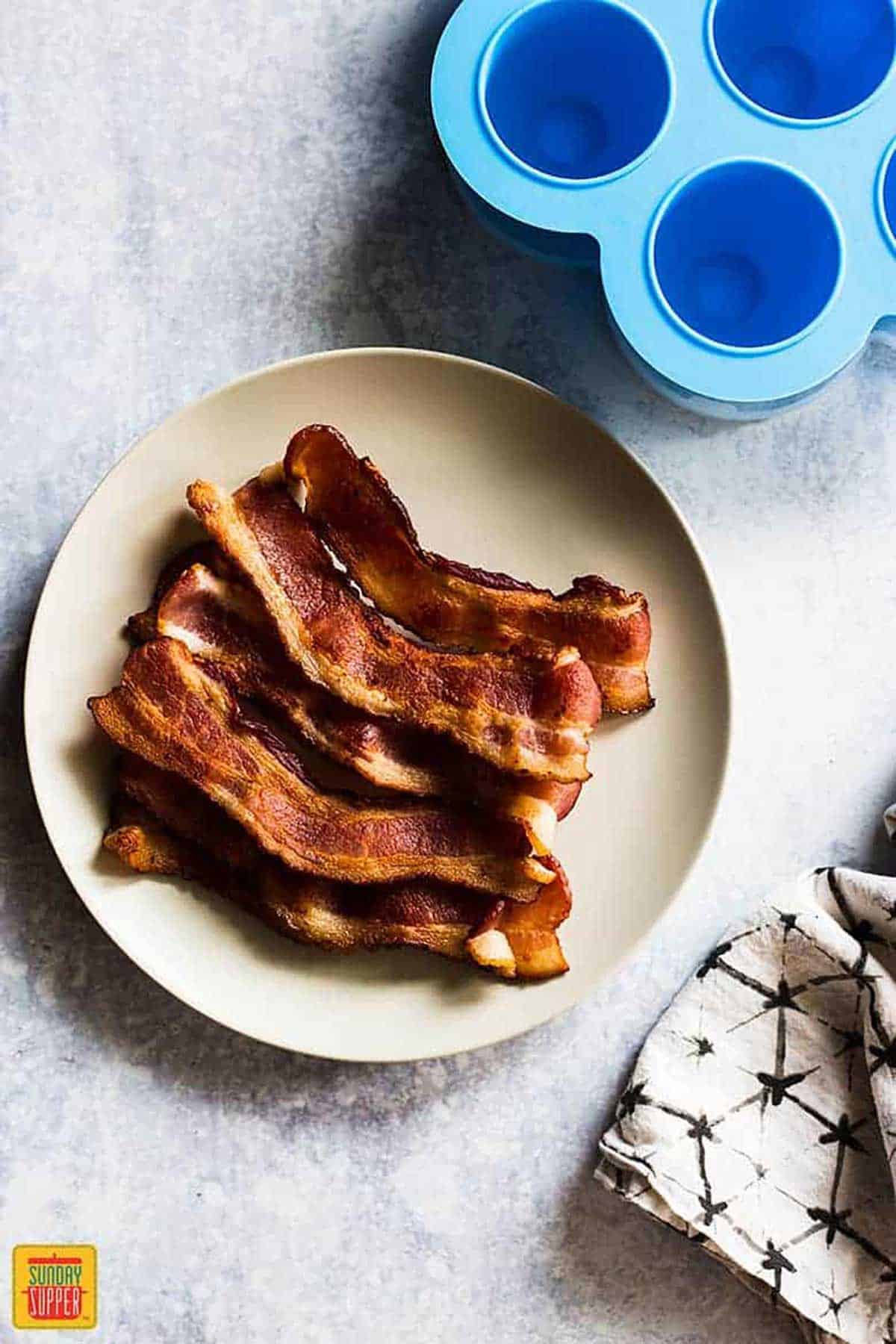 cooked bacon on a plate for starbucks egg bites